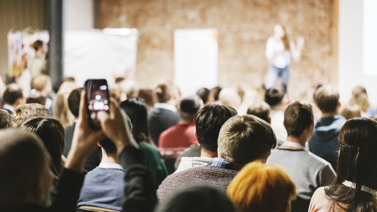 Contest Event People sitting in large room listening to speaker