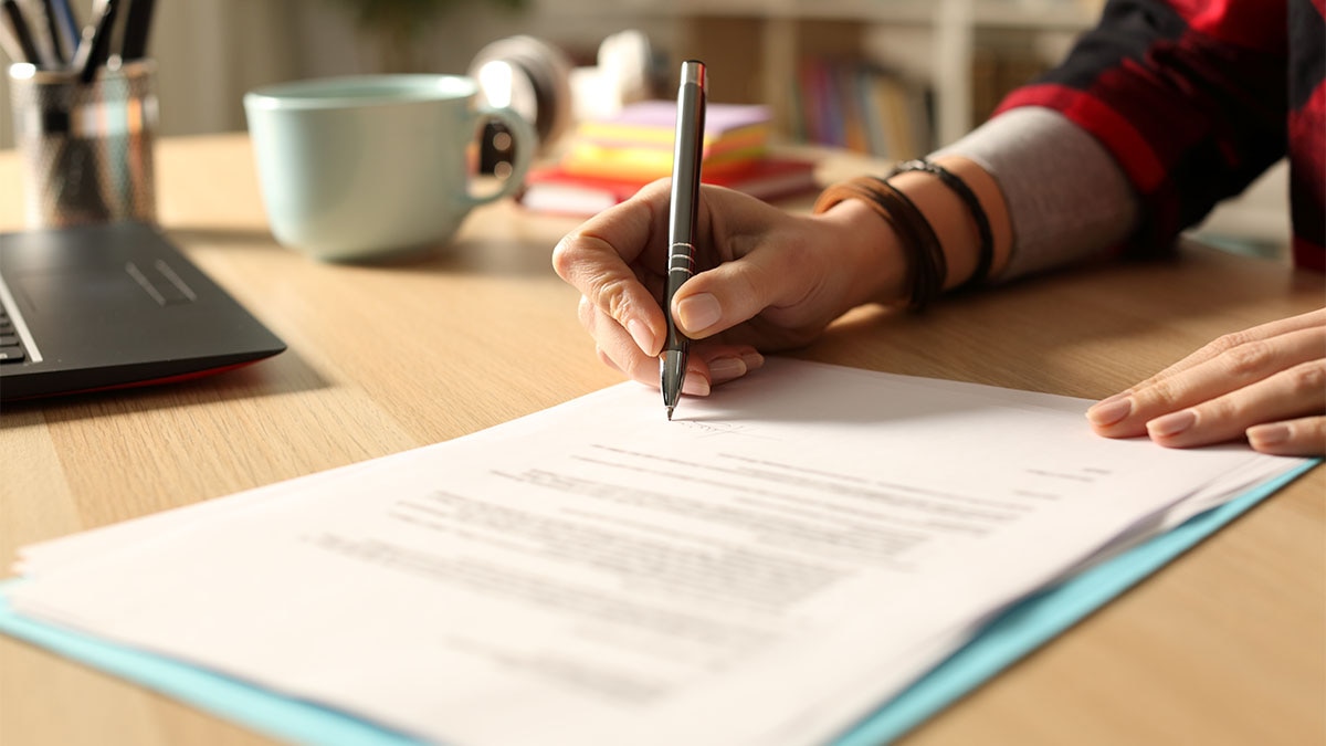 Faculty Grants Photo of person signing documents on desk