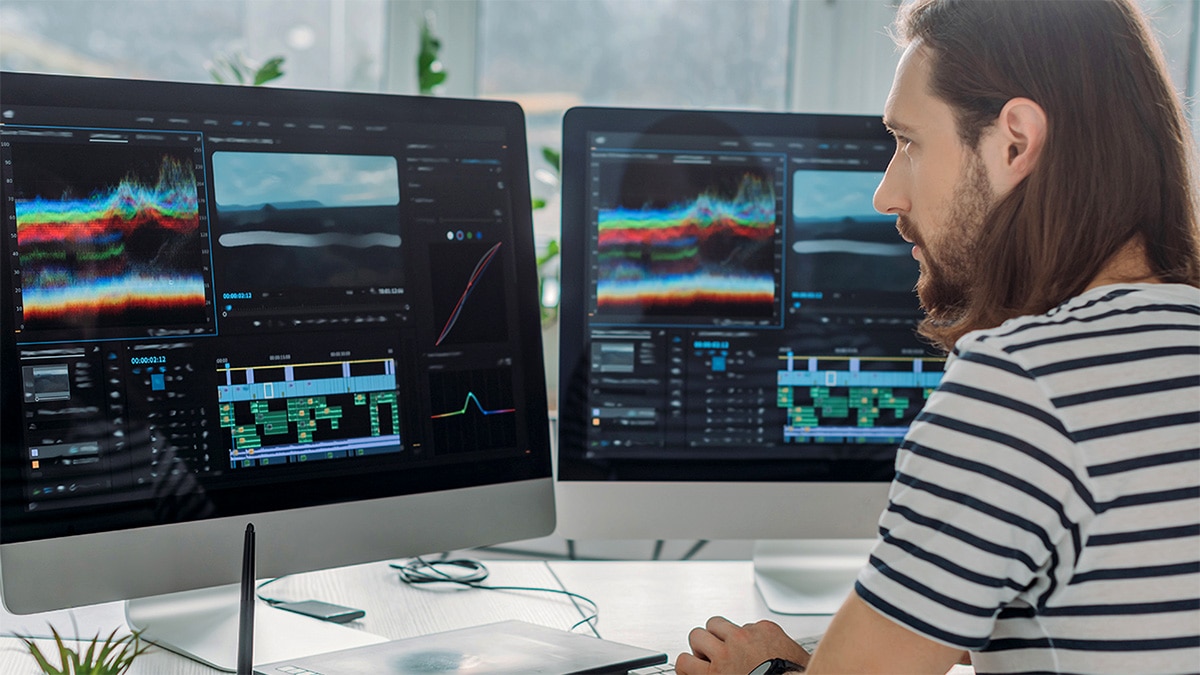 Man creating music on desktop computer Man creating music on desktop computer