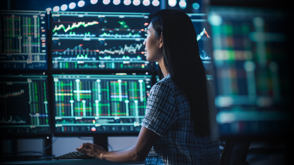 woman looking at computer screens woman looking at computer screens